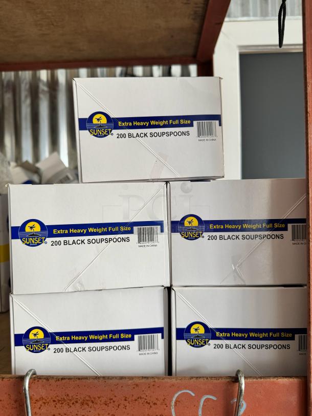 Boxes of Sunset Extra Heavy Weight Full Size black soup spoons, 200 per box, stacked on a shelf. Label shows "Made in China."