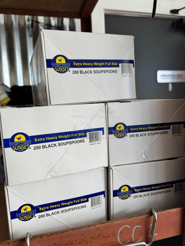Boxes of Sunset brand extra heavy weight full-size black soup spoons, 200 per box, labeled "Made in China."