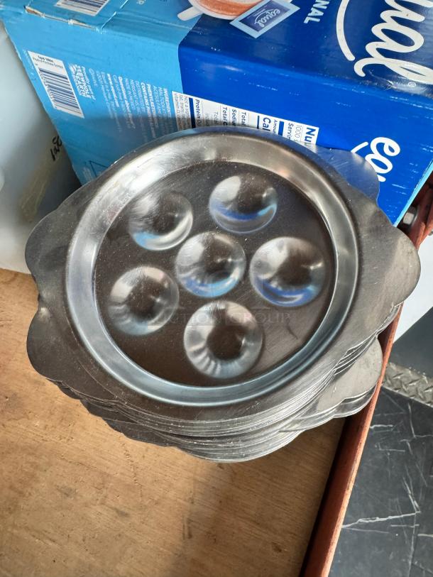 Stainless steel escargot dish BIDX25, with six rounded compartments, in good condition, ideal for serving escargot.