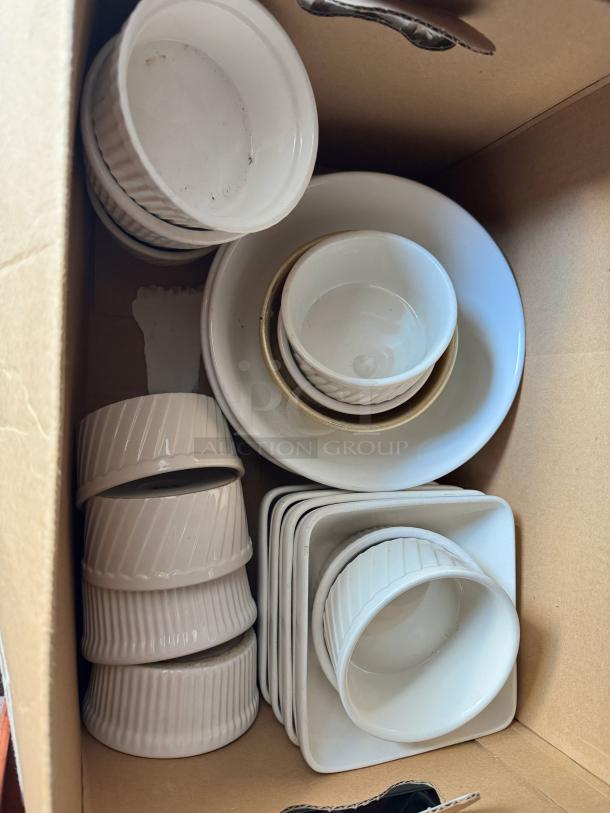 Box of miscellaneous porcelain dishes, including ramekins and square plates, in good condition. No visible markings.