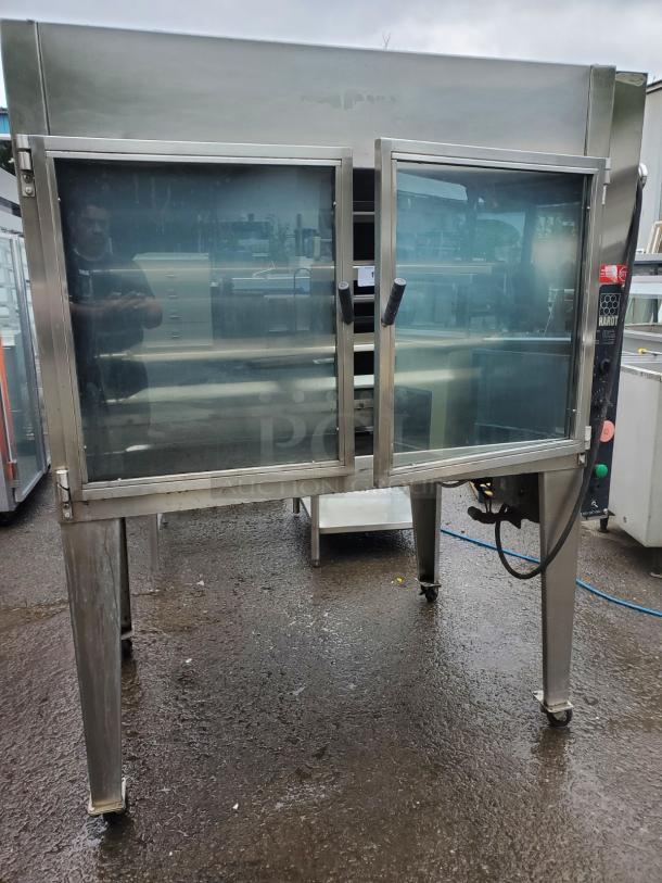HARD INFERNO Natural Gas Rotisserie Oven, stainless steel, dual glass doors, used condition, on caster wheels.