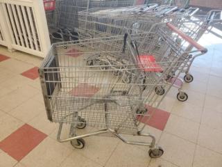 Lot of 2 metal shopping carts, used condition, with swivel wheels and red handle. Visible wear on surfaces.
