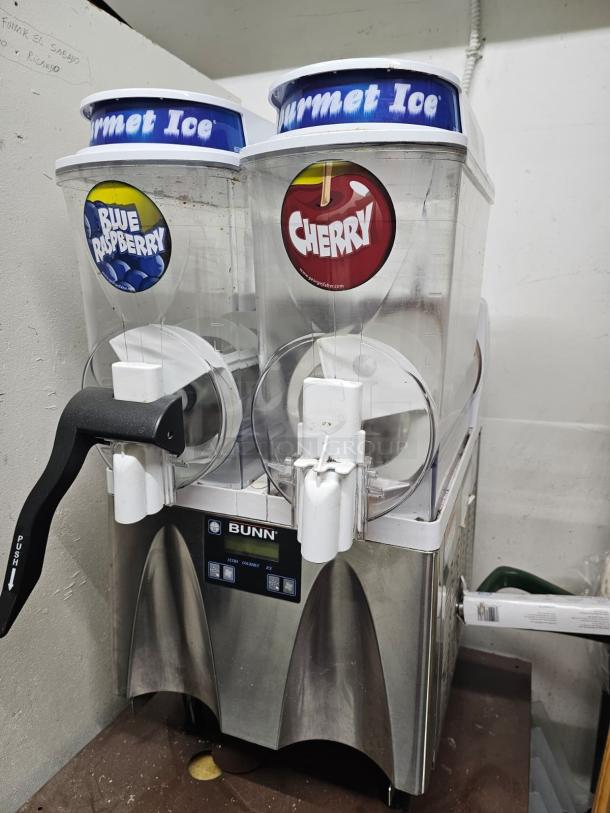 Bunn ULTRA-2 slushy machine, tested and working, stainless steel finish, missing one handle, labels for Blue Raspberry and Cherry flavors.