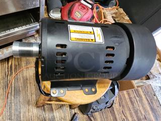 Brand new 3-phase induction motor ATHH-112M1-4, black casing, warning label, mounted on a wooden surface.