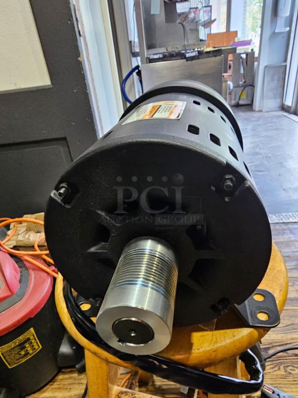 Brand new INDUCTION MOTOR ATHH-112M1-4, 3-phase. Features robust metal construction and visible product label.