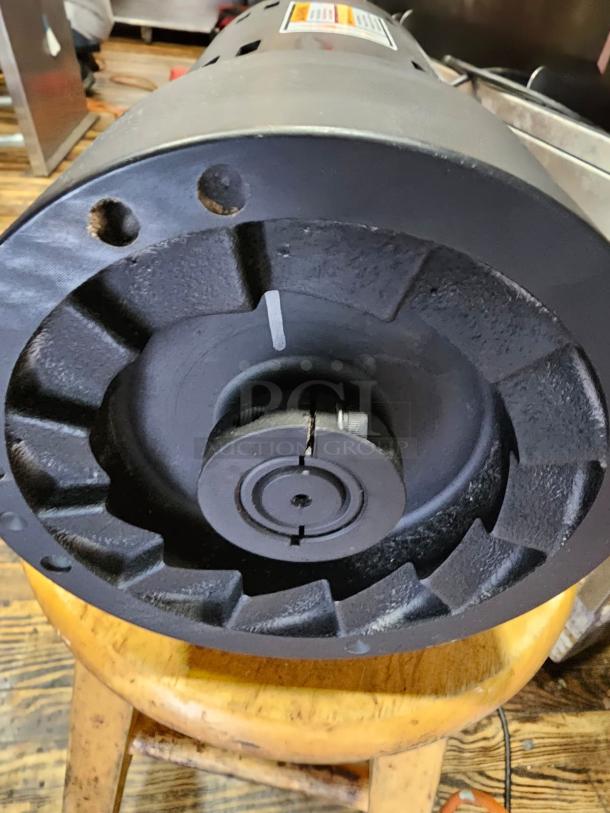 Brand new INDUCTION MOTOR ATHH-112M1-4, 3-phase, unblemished condition, detailed label and mounting features visible.