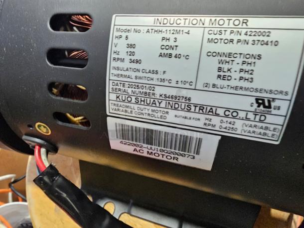 Brand new induction motor ATHH-112M1-4, 3-phase, 5 HP, 380V, 120Hz, 3490 RPM. Label shows specs, serial KS4592756.