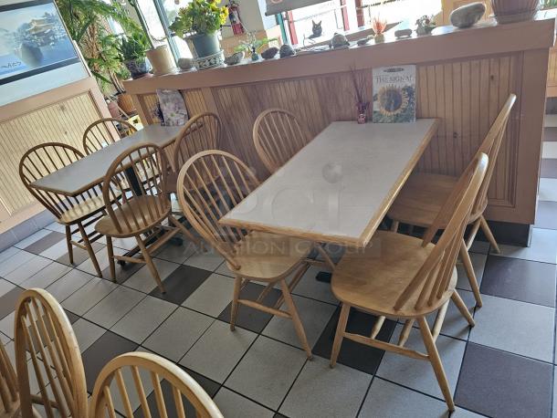 Wood dining chair BIDX5, natural finish, spindle back, lightly used condition. Set of matching chairs around tables, restaurant setting.