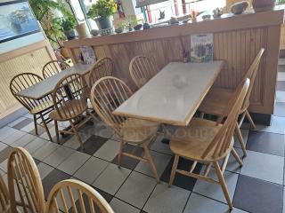 Wood dining chair BIDX5, natural finish, spindle back, lightly used condition. Set of matching chairs around tables, restaurant setting.