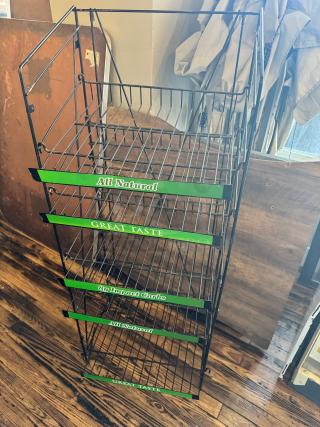 5-tier retail merchandising display rack, metal wire construction, green labels with "All Natural" and "Great Taste," sturdy condition.