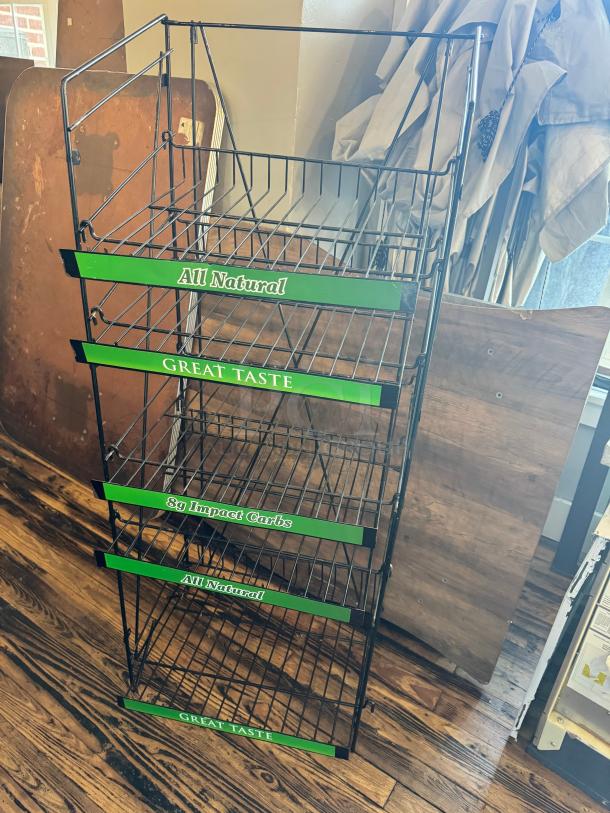 5-tier retail merchandising display rack with wire shelves, labeled "All Natural" and "Great Taste." Black metal frame, good condition.