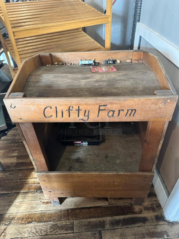 Vintage-style wooden display with "Clifty Farm" marking, rustic surface, sturdy construction, ideal for retail or decor.