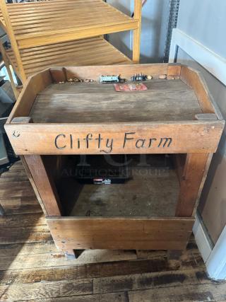 Vintage-style wooden display with "Clifty Farm" marking, rustic surface, sturdy construction, ideal for retail or decor.