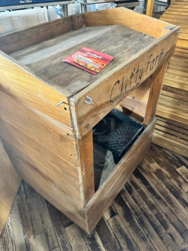 Vintage-style wooden display with "Clifty Farm" marking, rustic condition, featuring two shelves and an accessory on top.