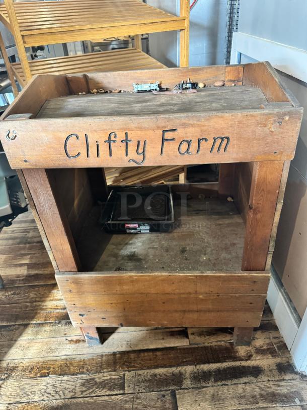 Vintage-style wooden display with "Clifty Farm" inscription, worn condition, rustic design, ideal for décor or retail display.