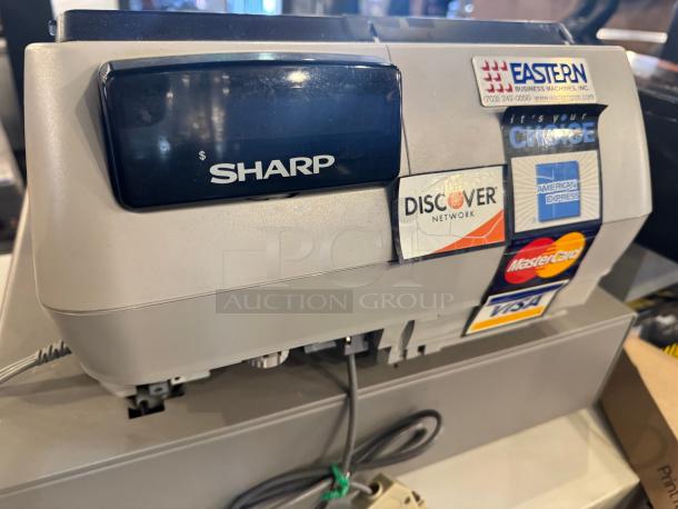 Sharp UP-700 POS terminal and cash register with visible brand stickers for payment options, in good condition.