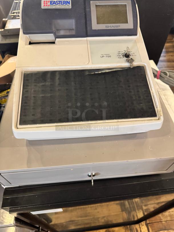 Sharp UP-700 POS terminal with cash register, includes keypad, display screen, and keys. Slight wear.