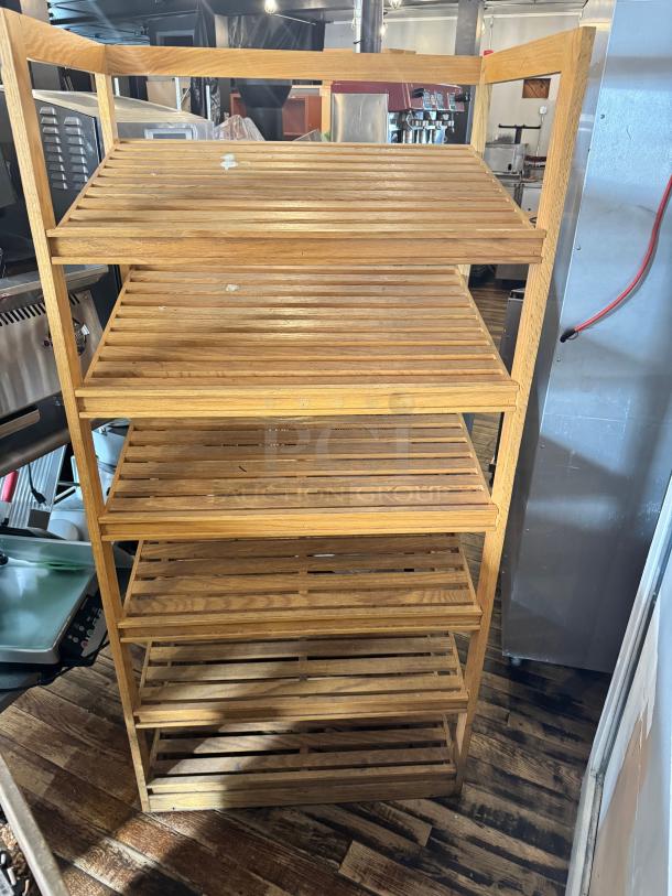 6-tier bamboo shelf with slatted design, showcasing natural finish. Appears in good condition, suitable for storage or display.