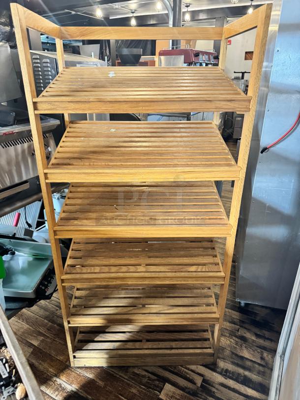 6-tier bamboo shelf with slatted design, natural finish. Some wear visible on shelves, sturdy construction, ideal for storage.