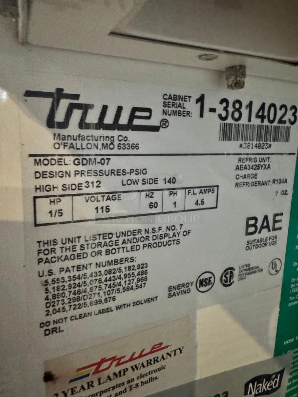 TRUE GDM-07 glass door cooler merchandiser label, includes model details, serial number 1-3814023, and specifications.