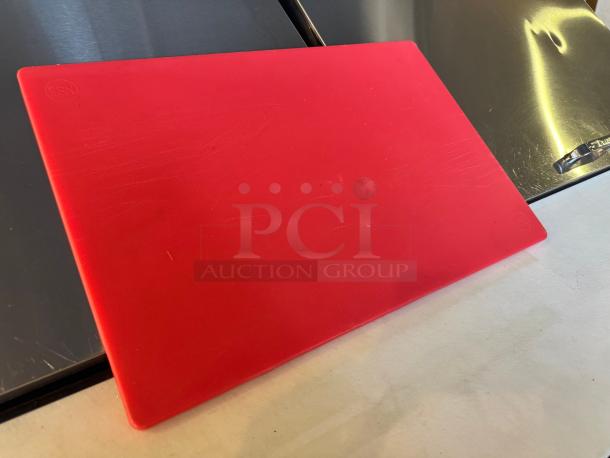 Red cutting board with light scratches, made of durable plastic. Features an embossed "ESN" mark in the corner.