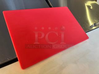 Red cutting board with light scratches, made of durable plastic. Features an embossed "ESN" mark in the corner.
