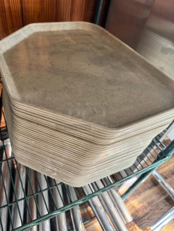 Stack of beige plastic trays, model BIDX35, in good condition on a metal rack, showing slight surface texture.