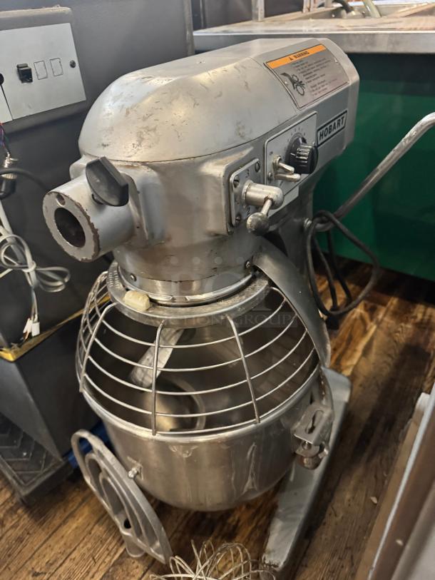 Hobart A200 20QT Mixer, 115V, includes attachments, metal bowl, controls, sturdy build, good condition with marks.