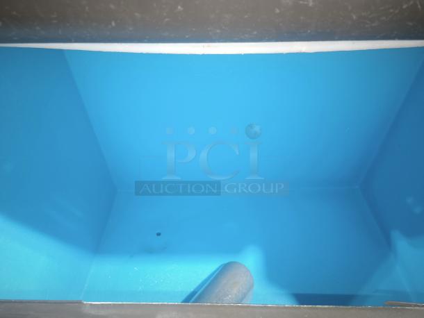 Interior of Manitowoc Ice IDT1500A/D970 ice machine bin, clean and spacious, with visible drainage hole.