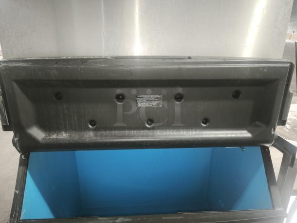 Manitowoc Ice IDT1500A/D970 ice machine with bin, air-cooled, 1688 lb capacity, 882 lb storage, slight wear visible.