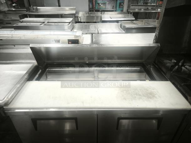 True 48" refrigerated prep table, model TSSU-48-12-HC, features a stainless steel work surface, ideal for sandwich prep.