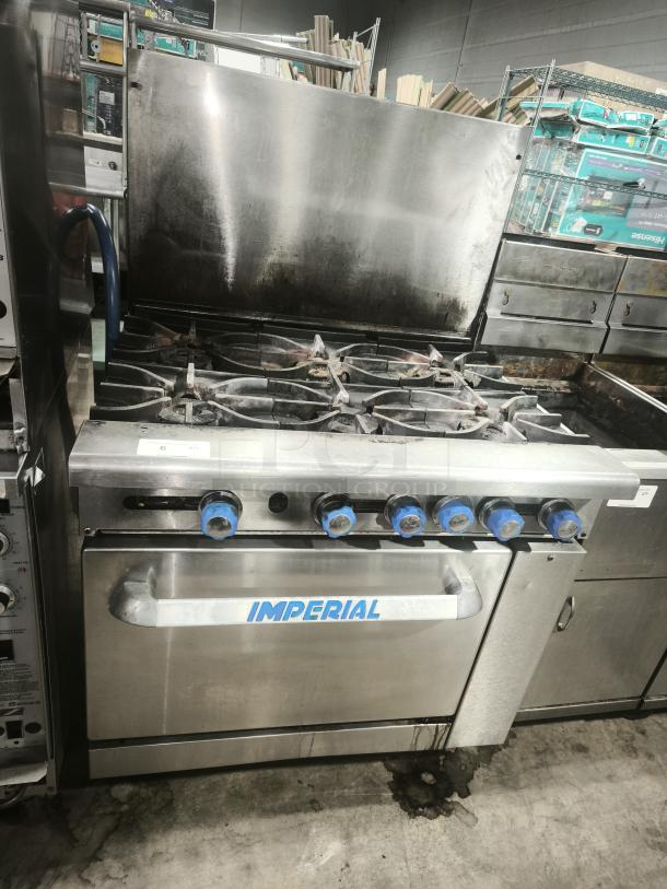 Imperial IR-6 36" 6 burner gas range with oven. Features natural gas usage. Notable wear on stainless steel surface.
