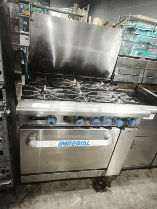 Imperial IR-6 36" 6 burner gas range with oven. Features natural gas usage. Notable wear on stainless steel surface.