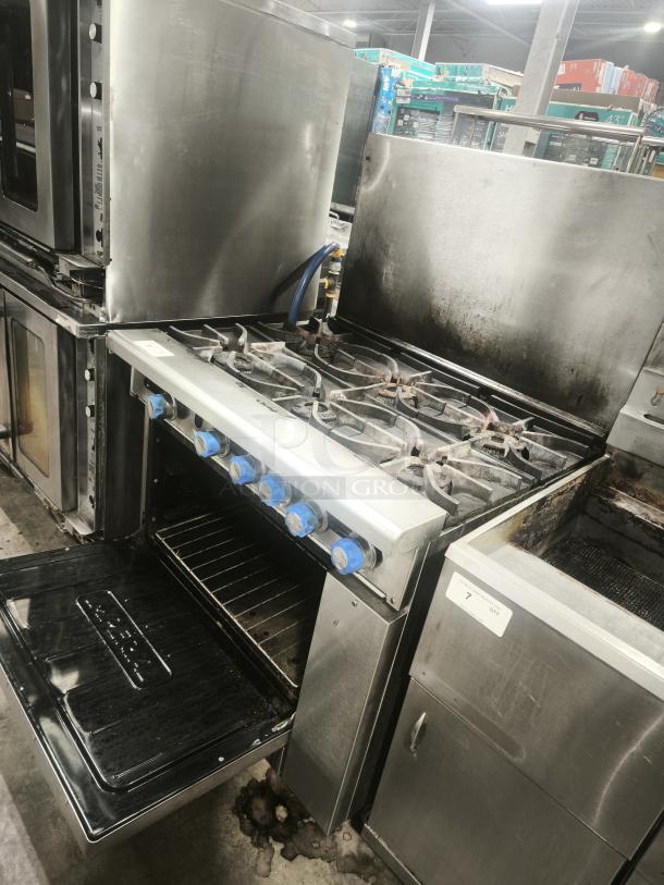 Imperial IR-6 36" gas range with 6 burners, standard oven; natural gas, used condition, visible wear, control knobs intact.