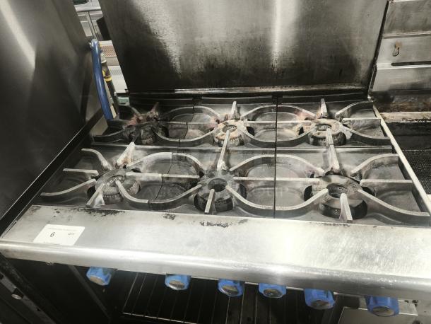 Imperial IR-6 36" 6-burner gas range with oven, natural gas, stainless steel, visible wear, with blue control knobs.