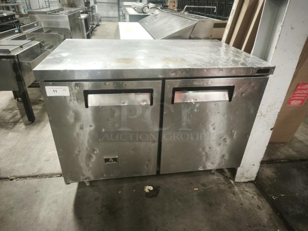 Kelvinator KCHUC48F 48" undercounter commercial freezer, two sections and doors, stainless steel, noticeable wear.
