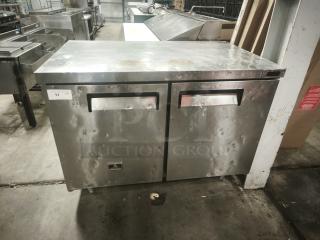 Kelvinator KCHUC48F 48" undercounter commercial freezer, two sections and doors, stainless steel, noticeable wear.