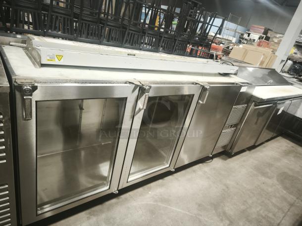 Glastender BB84-R1-SS 3-door stainless steel back bar fridge, 84", under-counter, used condition, visible handles.