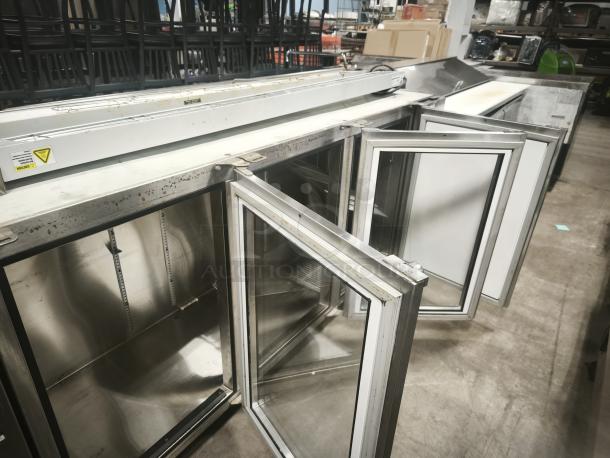 Glastender BB84-R1-SS 3-Door Back Bar Under Counter Refrigerator, stainless steel, used condition, doors open, industrial setting.