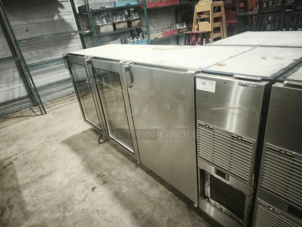 Glastender 84" stainless steel back bar cooler, model BB84-L1-XS(RRR), with 3 glass doors. Some surface wear visible.
