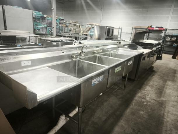 Stainless steel heavy-duty 3 compartment sink with faucet, drainboards, and visible labels. Suitable for commercial use.