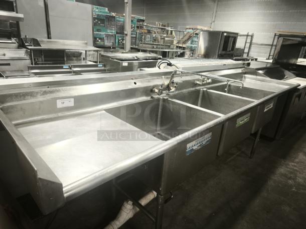 Heavy-duty 3-compartment stainless steel sink with dual faucets, labeled "WASH RINSE SANITIZE." Ideal for commercial use.