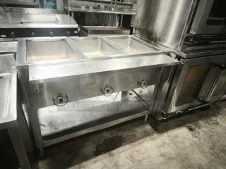 Commercial stainless steel heavy-duty steamer with three compartments, control knobs, and sturdy legs, in used condition.