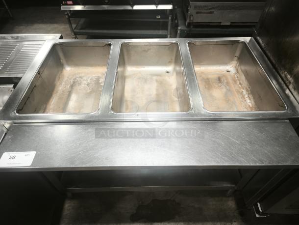 Heavy-duty stainless steel steamer with three compartments, showing signs of use. Auction tag "20 QTY" visible on front.