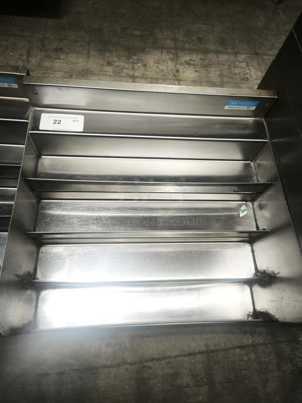 Heavy-duty stainless steel pan racks with multiple shelves, showing light wear. Label indicates 22 quantity available.