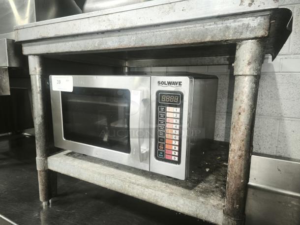 SOLWAVE heavy-duty commercial microwave, stainless steel, digital controls, on metallic shelf, used condition, auction tag 39.