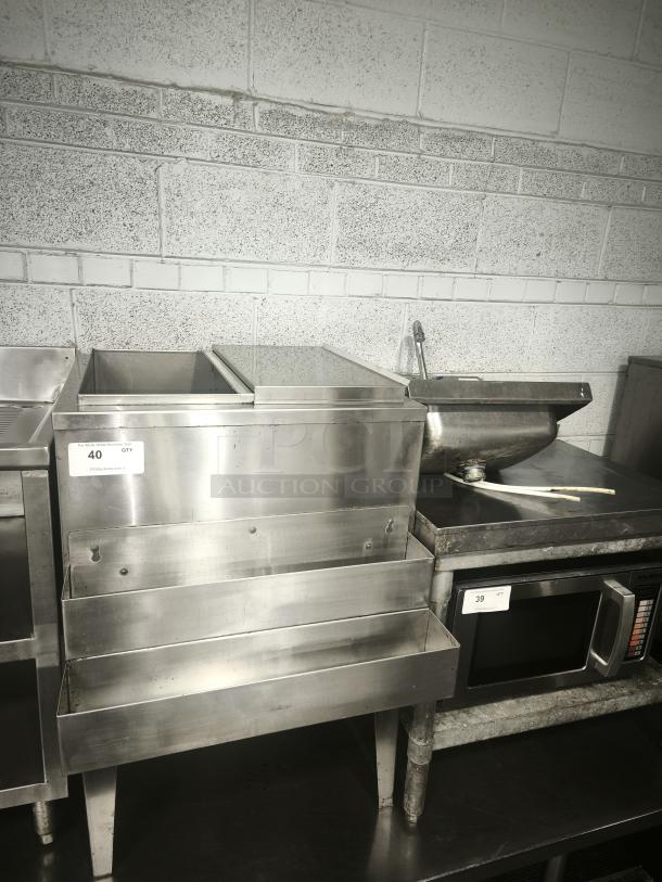Stainless steel underbar ice bin and cocktail unit with built-in 7-circuit cold plate. Features tiered shelves. Good condition.