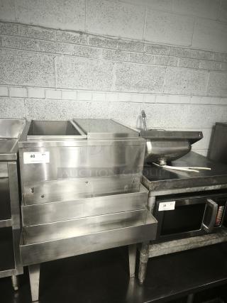 Stainless steel underbar ice bin and cocktail unit with built-in 7-circuit cold plate. Features tiered shelves. Good condition.