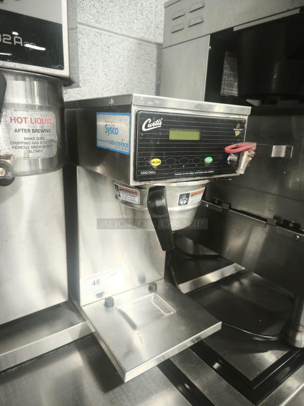 Curtis D60GT63A000 thermal coffee maker, automatic, 9 gal/hr, 120/220v. Features control panel, Sysco label indicating distribution.