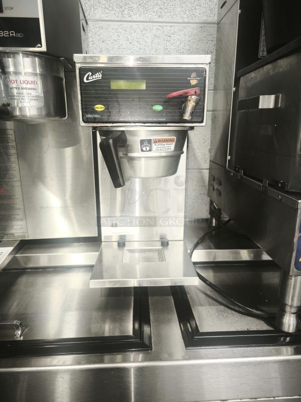 Curtis D60GT63A000 coffee maker, automatic, medium volume, 9 gal/hr, 120/220v. Features on/off switch, warning labels.